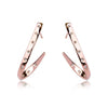 These loop earrings are rose gold and feature small swarovski crystal studs along the metal. They do not complete a full loop, as they descend they begin to sloop away from the head, then tail back in to almost point back at the beginning of the earrings.