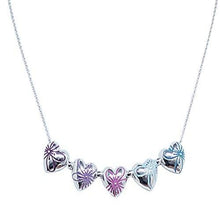  This necklace has 5 hearts each a different colour. From the observers left, the colours read dark purple, purple, pink, light blue, blue. The hearts are majority silver, the colours features draw a flower head over the hearts.