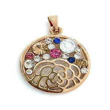  This pendant is circular in shape with a diameter of 3 centimetres. The circle itself is hollow with a flower outline taking up the bottom half. On the horizon above the flower are a series of swaroski crystals ranging in sizes and consisting of red, blue, white, silver and gold crystals.