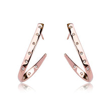  These loop earrings are rose gold and feature small swarovski crystal studs along the metal. They do not complete a full loop, as they descend they begin to sloop away from the head, then tail back in to almost point back at the beginning of the earrings.