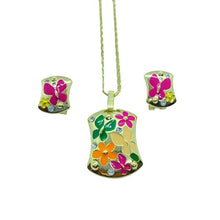  This enamel butterfly set includes a necklace and a set of earrings. The Earrings each feature a pink butterfly with some flowers surrounding it. On the necklace there are 3 butterflies in green, pink and beige. These butterflies are also accompanied by two flowers in pink and orange, as well as a couple of small swarovski crystal studs.